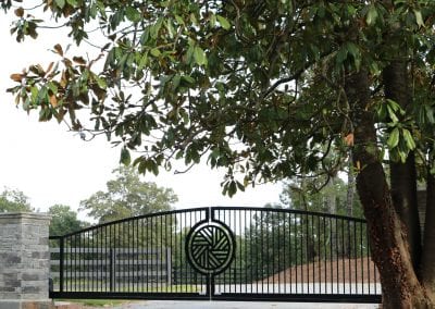 Elegant black metal gate at Millstone Stables entrance.
